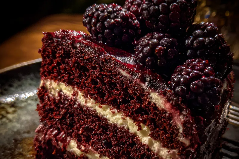 Chef Mitchell mixing the ingredients for Blackberry Velvet Indulgence in a mixing bowl.
