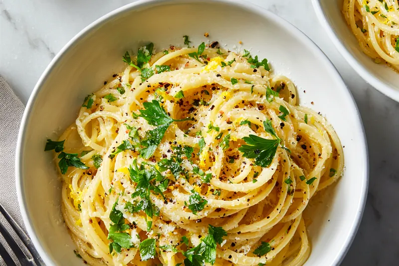 Fresh ingredients laid out for Creamy Shrimp Spinach Pasta Rolls including shrimp, spinach, cheese, and pasta.