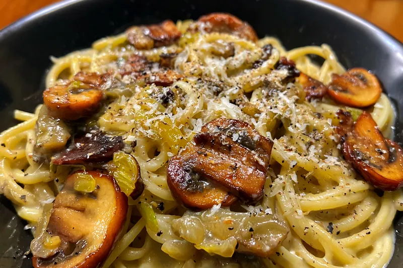A step-by-step process showcasing the cooking of Mushroom Gruyere Pasta in a skillet.
