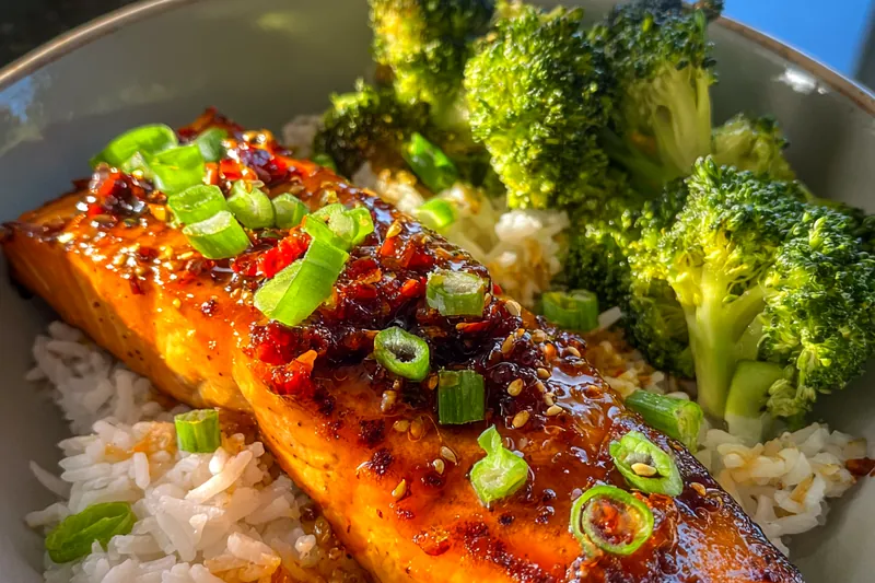 Chef Mitchell sautéing garlic and ginger for the Savory Firecracker Salmon in a skillet.